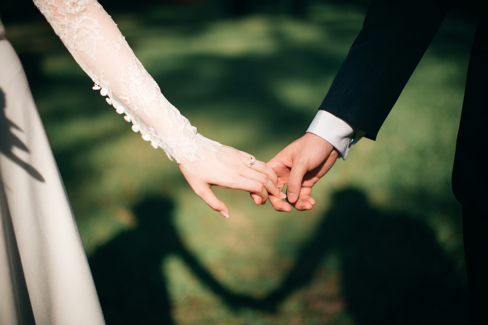 The couple backlit by sun, bouquet in front