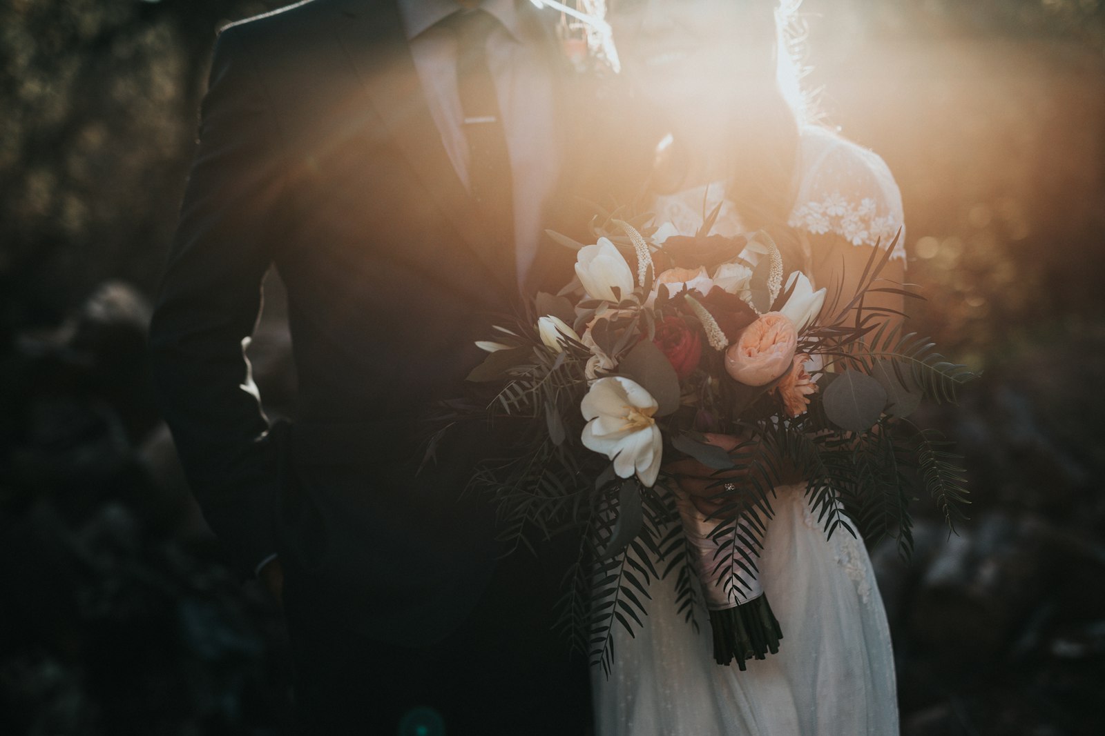 Bride and groom holding hands on the lawn