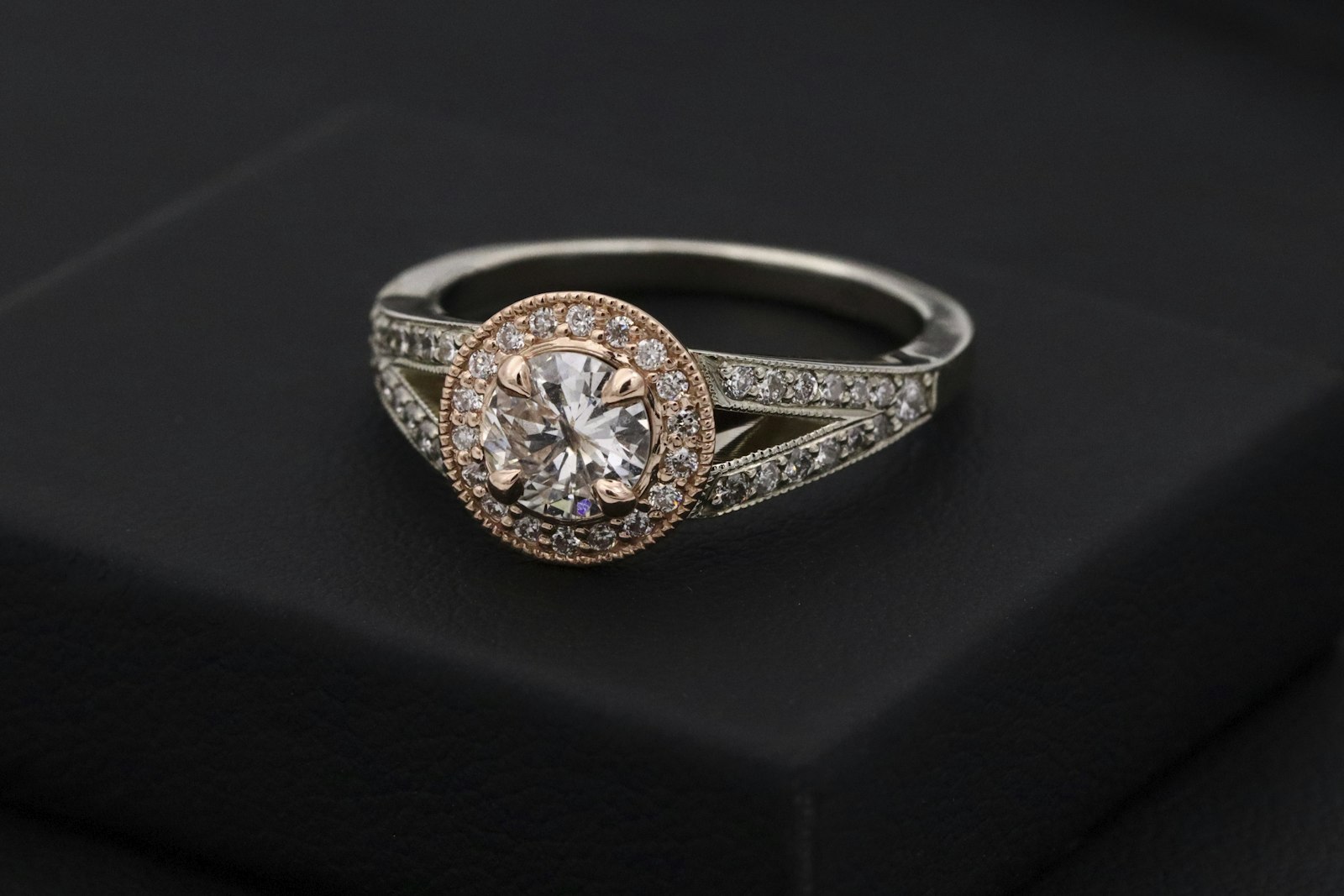 A diamond engagement ring in macro on dark silk